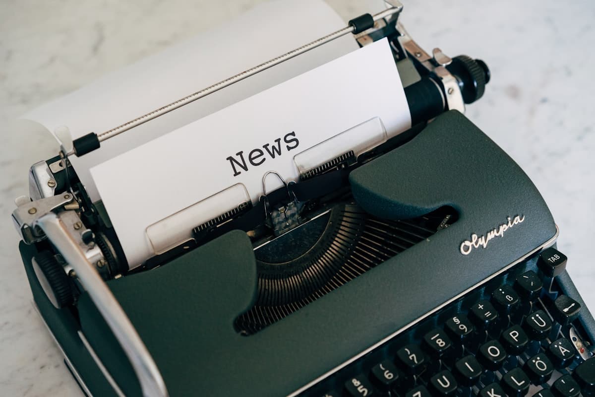 A typewriter typing the word News.
